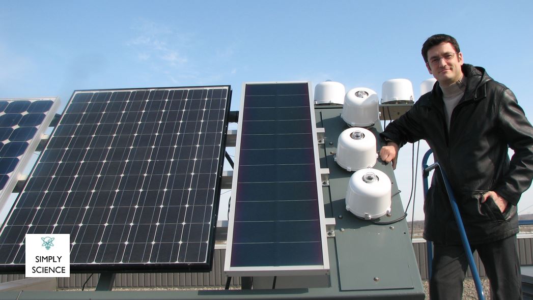 Yves Poissant standing next to a photovoltaic system.